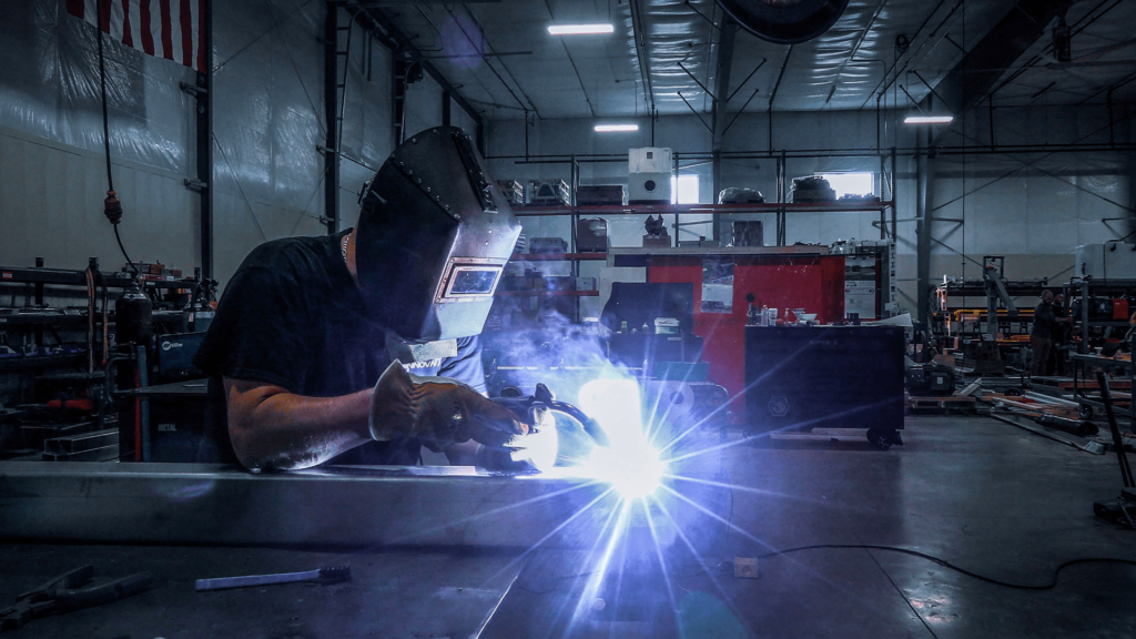 Man welding in a warehouse