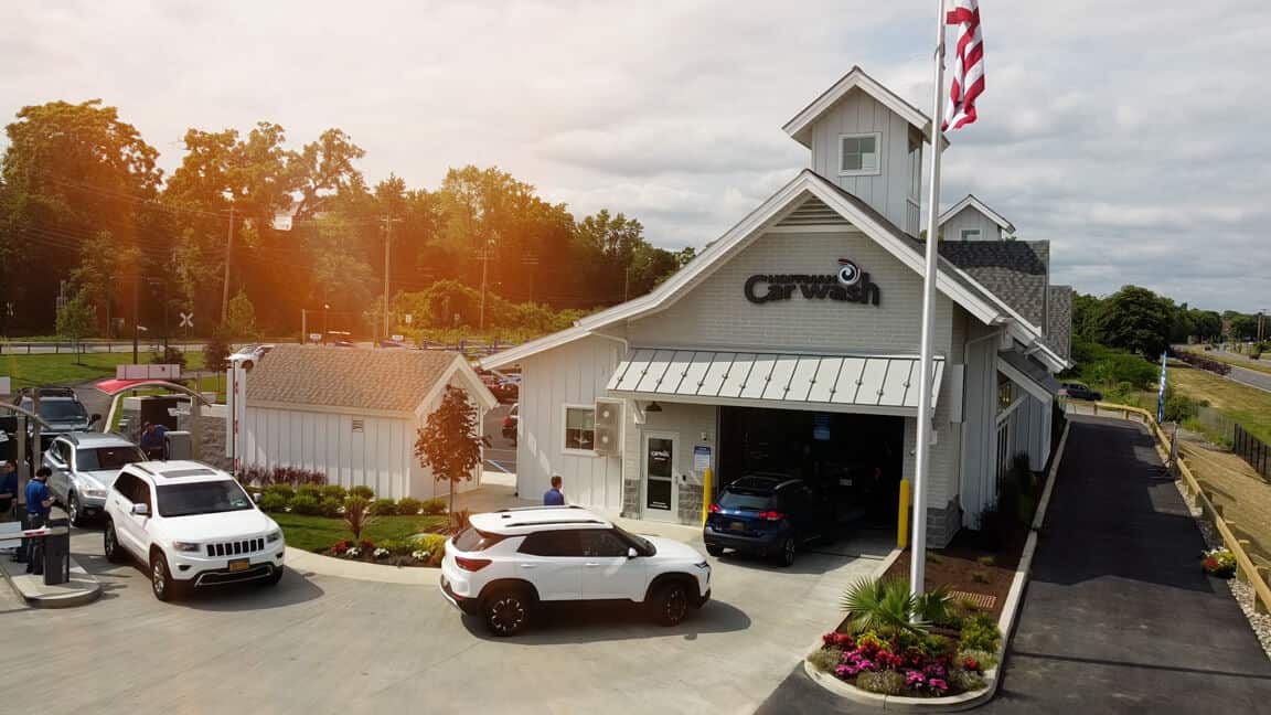 Cars lined up to go into the car wash tunnel
