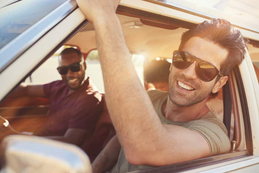 Group Of Friends Relaxing In Car During Road Trip