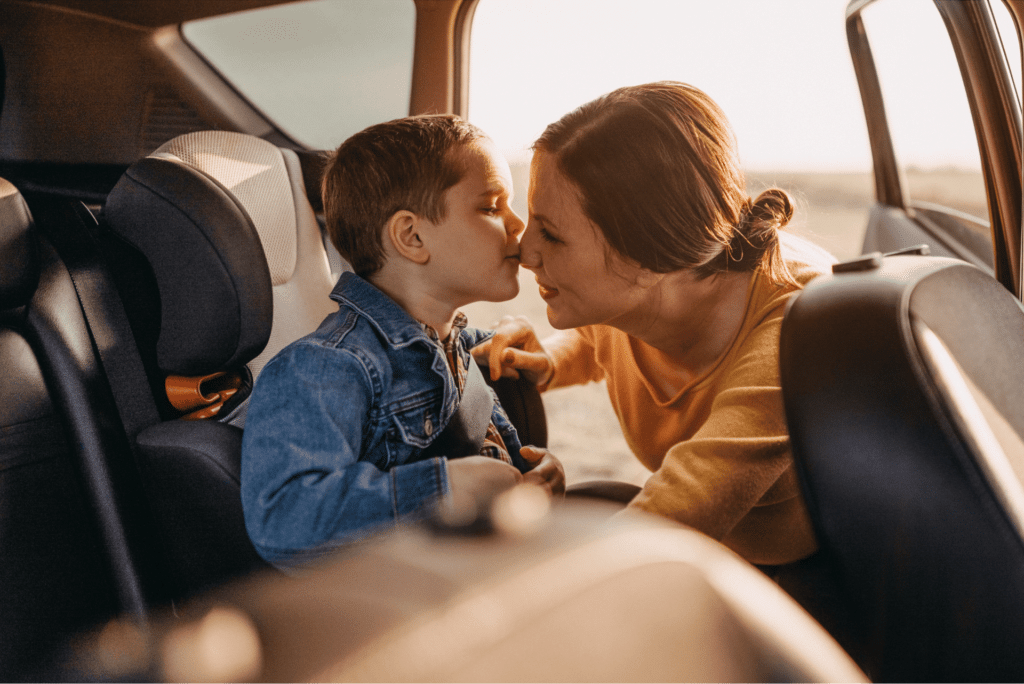 Photo of a boy kissing his mother on the nose