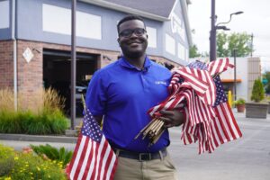 A man holding American flags in his hands