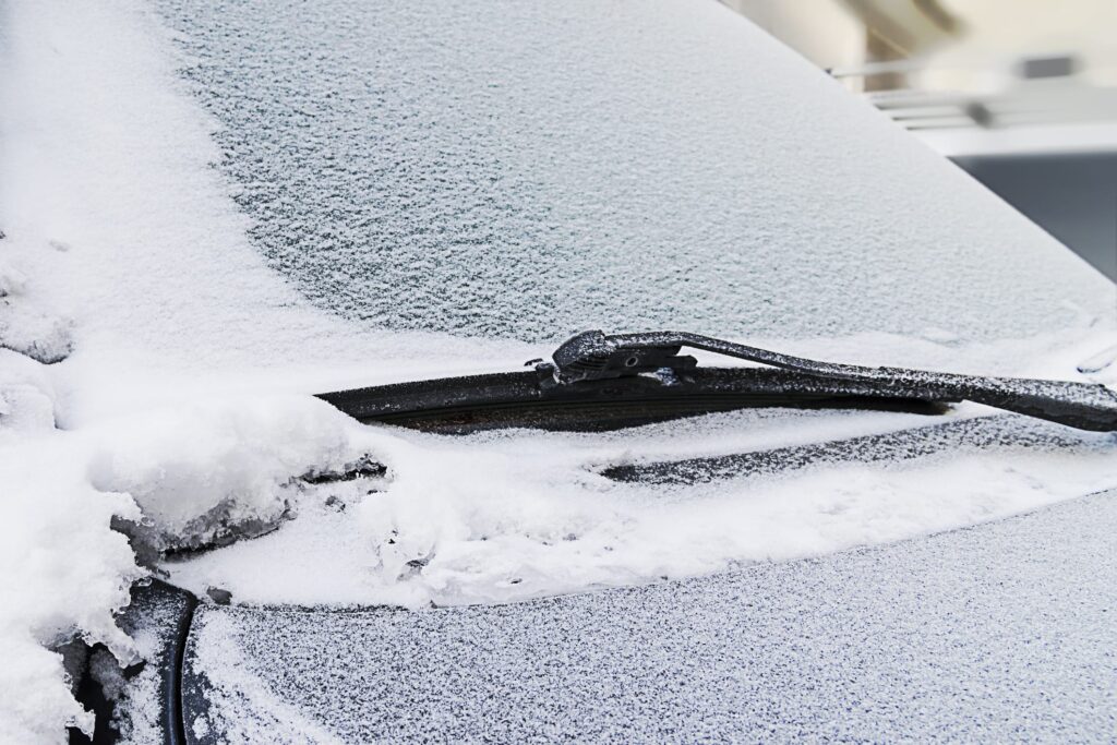 Frozen car windshield covered with