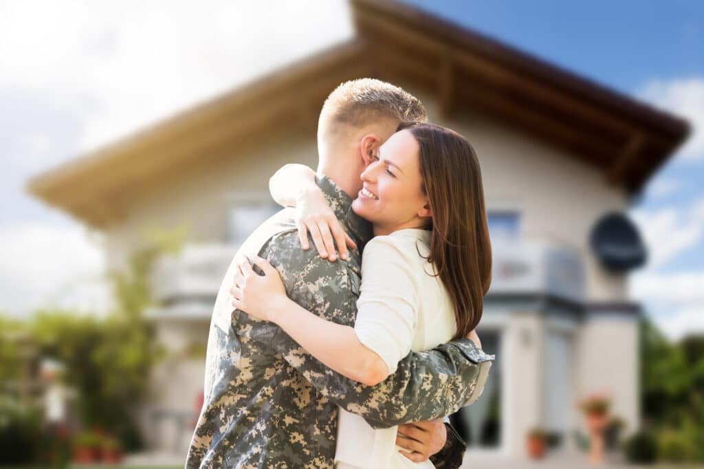 Portrait Of Happy Wife Hugging Her Husband In Army Uniform